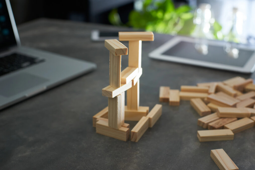 Wooden building blocks stacked on top of a desktop